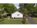 The rear of the home shows the side yard, driveway, and greenery at 700 Sawmill Rd, Raleigh, NC 27615