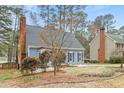 This home features a brick chimney, and classic blue siding with blue shutters at 7112 Benhart Dr, Raleigh, NC 27613