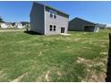 Expansive backyard with healthy green grass, perfect for outdoor activities and relaxation at 817 Kenyon Springs Dr, Zebulon, NC 27597