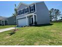 Attractive two-story home with gray siding, well-maintained landscaping, and attached garage at 817 Kenyon Springs Dr, Zebulon, NC 27597