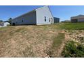 A view of a backyard with newly seeded grass, showcasing outdoor space potential at 821 Kenyon Spring Dr, Zebulon, NC 27597