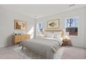 Serene bedroom with natural light, neutral decor, and stylish wooden furniture at 821 Kenyon Spring Dr, Zebulon, NC 27597