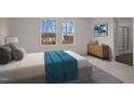Comfortable bedroom with two windows providing ample light, complemented by stylish modern decor at 845 Kenyon Spring Dr, Zebulon, NC 27597
