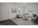 Cozy living room featuring modern furniture, a large window, and dark wood-look flooring at 845 Kenyon Spring Dr, Zebulon, NC 27597