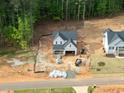 Aerial view of a home under construction in a new neighborhood, highlighting its setting near wooded areas at 85 Purslane Dr, Franklinton, NC 27525