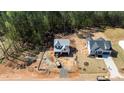 Aerial view of a two-story home under construction showcasing the surrounding neighborhood and trees at 85 Purslane Dr, Franklinton, NC 27525