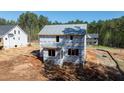 New two-story home under construction featuring a durable weather-resistant wrap and trimmed window openings at 85 Purslane Dr, Franklinton, NC 27525