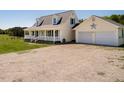 Home exterior with front porch and attached two-car garage with ample parking at 850 Cheatham Mabry Rd, Henderson, NC 27537