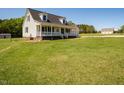 Two-story home with a welcoming front porch and expansive green yard at 850 Cheatham Mabry Rd, Henderson, NC 27537