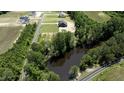 An aerial view of the home, showcasing its location near a pond, roads and a community at 8620 Dukes Lake Rd, Zebulon, NC 27597
