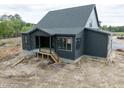New construction home with gray siding and an in-progress backyard at 8620 Dukes Lake Rd, Zebulon, NC 27597