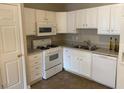 Bright kitchen featuring white cabinetry, a microwave, and modern appliances at 8650 Neuse Landing Ln # 101, Raleigh, NC 27616