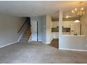 Spacious living room features neutral carpet, and a staircase to the upper level at 8650 Neuse Landing Ln # 101, Raleigh, NC 27616