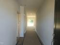 Bright hallway with gray walls leads to a living area with a sliding glass door at 89 Grove Township Way, Angier, NC 27501