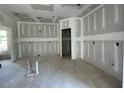 Spacious living room featuring sheetrocked walls awaiting personalization and finishing touches at 89 Grove Township Way, Angier, NC 27501