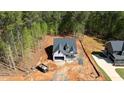 Aerial view of new home construction shows roof and construction progress on wooded lot at 90 Purslane Dr, Franklinton, NC 27525