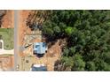 Aerial view of new construction neighborhood with one home in progress and wooded surrounding at 90 Purslane Dr, Franklinton, NC 27525