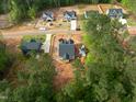 New homes nestled in a community bordered by lush trees, as seen from an aerial perspective at 90 Purslane Dr, Franklinton, NC 27525