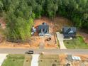 Aerial view of new home construction in a wooded community, showcasing the neighborhood layout at 90 Purslane Dr, Franklinton, NC 27525