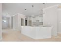 Spacious kitchen featuring white cabinets, modern pendant lighting, and expansive island at 90 Purslane Dr, Franklinton, NC 27525