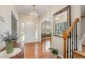 Bright foyer features hardwood floors, chandelier, and views into adjacent rooms, enhancing the home's welcoming ambiance at 106 Teak Cir, Garner, NC 27529