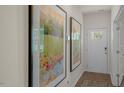 Inviting hallway with artwork and a door with glass pane at 1105 Ursa Major Ct, Wendell, NC 27591