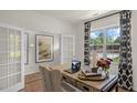 Bright office space with French doors, a large window, and stylish decor at 1105 Ursa Major Ct, Wendell, NC 27591