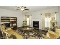Elegant living room with fireplace, large windows, and decorative seating at 1108 Agio Ct, Zebulon, NC 27597