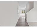 Long hallway with hardwood floors leading into a carpeted living space at 129 Gladstone Loop, Clayton, NC 27520