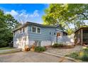 Spacious backyard featuring a stone patio, lush landscaping, and a screened-in porch, perfect for outdoor living at 1518 Echo Rd, Durham, NC 27707