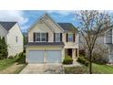 Charming two-story home with a two-car garage, mature trees, and well-maintained landscaping at 1533 Brown Owl Dr, Raleigh, NC 27610
