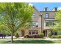 Charming brick townhouse with stone accents, dormer windows, and lush green landscaping at 1601 Bowery Dr, Raleigh, NC 27607