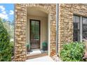Inviting front entrance features a stone surround, elegant door, and manicured landscaping at 1601 Bowery Dr, Raleigh, NC 27607