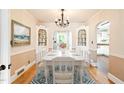 Elegant dining room with hardwood floors, built-in cabinets, and a stylish chandelier at 1617 Woodland Ave, Burlington, NC 27215