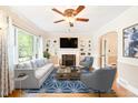 Bright living room featuring a cozy fireplace, built-in bookshelves, and a large window at 1617 Woodland Ave, Burlington, NC 27215