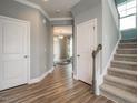 Inviting foyer featuring hardwood floors, a staircase, and access to various rooms at 2006 Cross Bones Blvd # 34, Durham, NC 27703