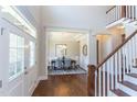Welcoming foyer with hardwood floors leading to an elegant dining room at 205 Riverine Dr, Pittsboro, NC 27312