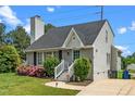 Charming single-story home featuring a well-manicured lawn, quaint front porch, and inviting light-blue front door at 2108 Quail View Trail, Raleigh, NC 27604