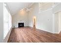 Spacious living room with a high ceiling, a cozy fireplace, and hardwood-style flooring at 2108 Quail View Trail, Raleigh, NC 27604