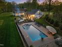 Expansive backyard with a large swimming pool, outdoor kitchen, and patio area, perfect for entertaining at 2259 Helena Moriah Rd, Timberlake, NC 27583