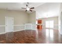 Open-concept living room with beautiful hardwood floors and a decorative fireplace flowing into the kitchen at 24 Cider Ct, Benson, NC 27504