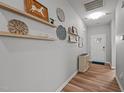 Bright entryway features wood-look flooring, decorative shelves, and a view of the front door at 252 Tyree Trl, Burlington, NC 27215