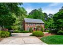 Brick home with lush green landscaping and a circular driveway at 2720 Townedge Ct, Raleigh, NC 27612