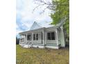 Quaint single-Gathering home showing the exterior with a inviting front porch and traditional architecture at 305 N Webb St, Selma, NC 27576