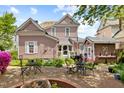 Charming backyard with brick patio, outdoor seating, lush landscaping, and a small outbuilding at 308 S Pearl St, Rocky Mount, NC 27804