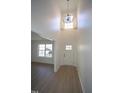 Bright entryway featuring tall ceilings, modern light fixture and a charming front door with glass accents at 3244 Marcony Way, Raleigh, NC 27610