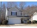 Charming two-story home with mature trees, manicured bushes, attached two car garage and lovely front porch at 3244 Marcony Way, Raleigh, NC 27610