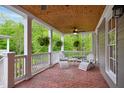 Cozy covered porch with brick flooring, comfortable seating, and views of the surrounding greenery at 3332 Cheswick Dr, Raleigh, NC 27609