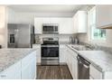 Modern kitchen showcasing stainless steel appliances, granite countertops, and ample cabinet space at 363 Tormore Dr, Sanford, NC 27330