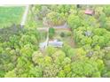 Aerial view of a well-maintained home surrounded by lush greenery and mature trees at 3954 Piney Grove Church Rd, Siler City, NC 27344